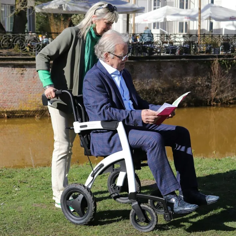 A carer holding an elderly person's hands